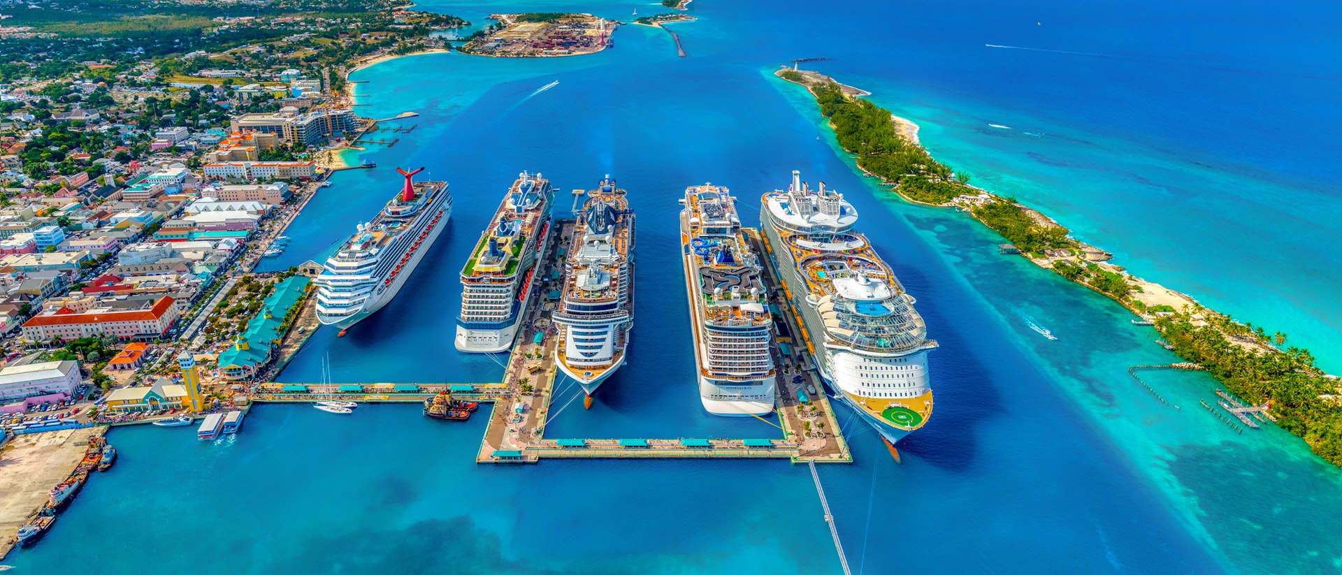 Sleek luxury cruise ship anchored in a turquoise Mediterranean cove at golden hour