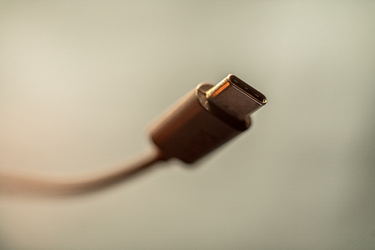USB-C charger and cable on wooden surface