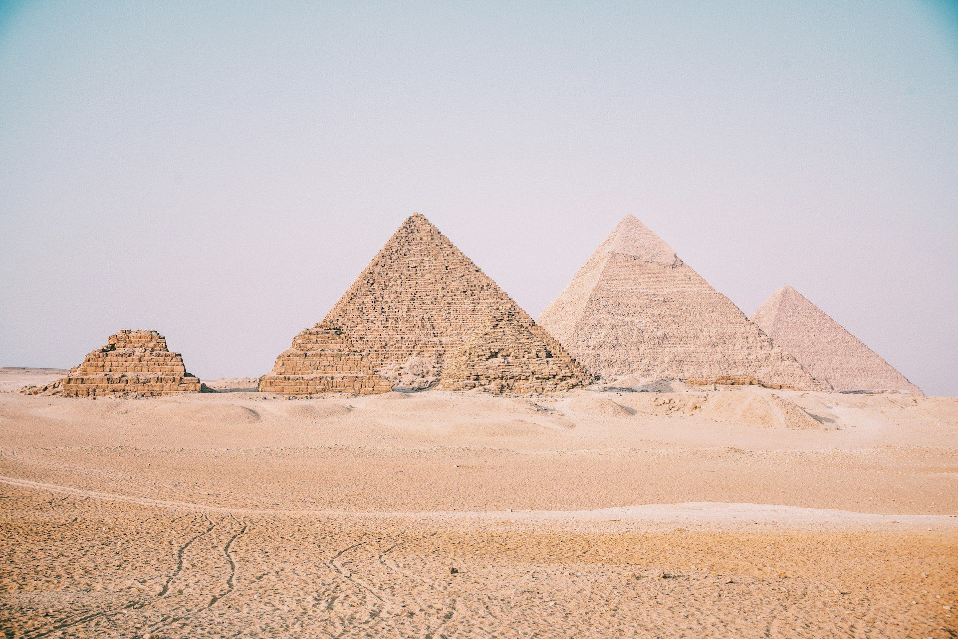 The Great Pyramids of Giza at sunset with the Sphinx in the foreground