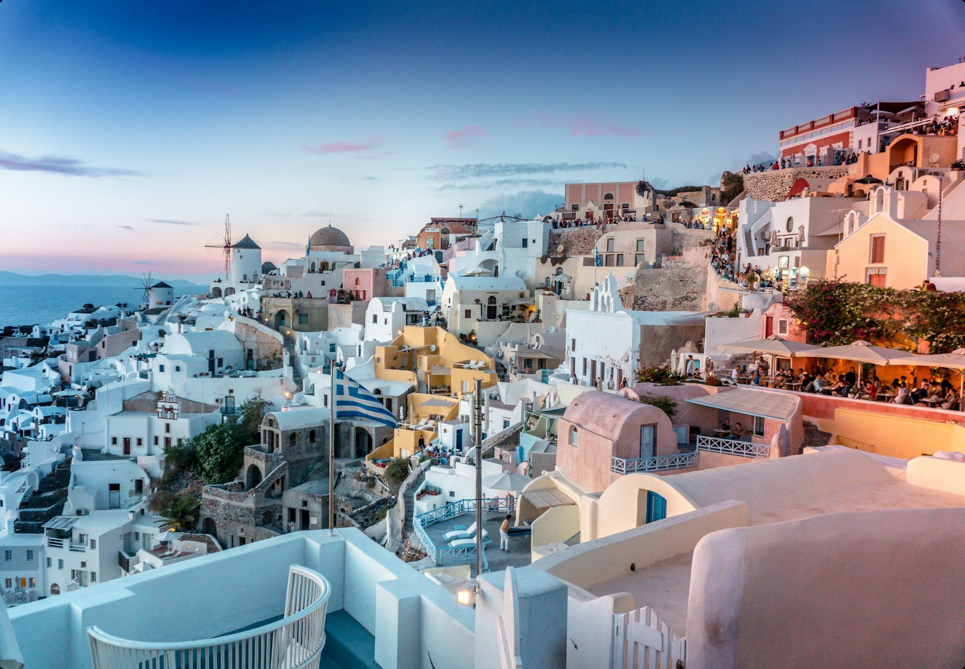 Santorini's white and blue buildings overlooking the caldera at sunset