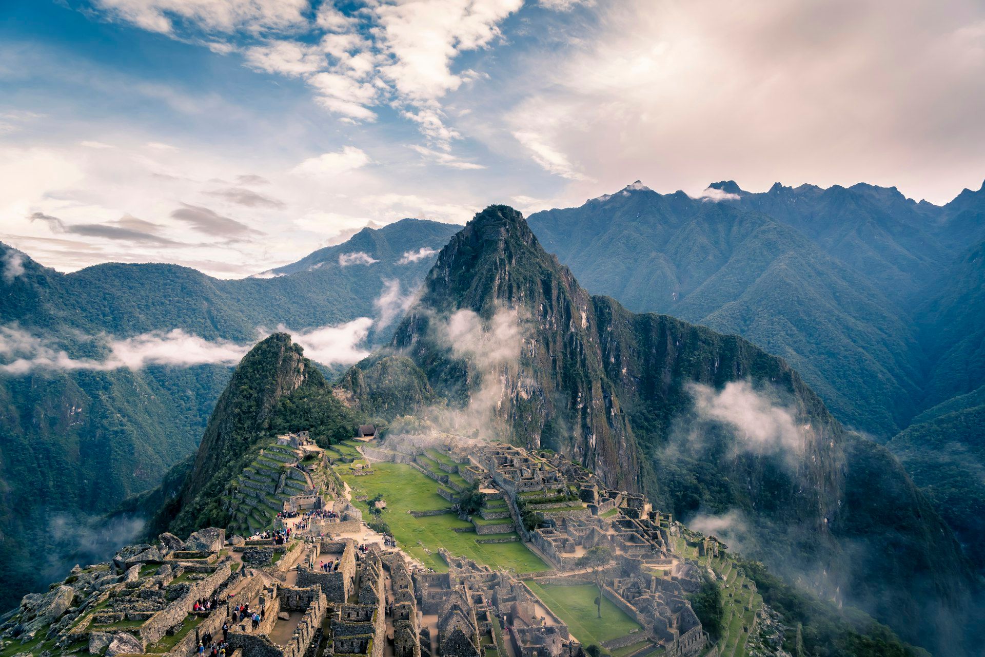 Machu Picchu ruins with dramatic clouds rolling through the Andes mountains