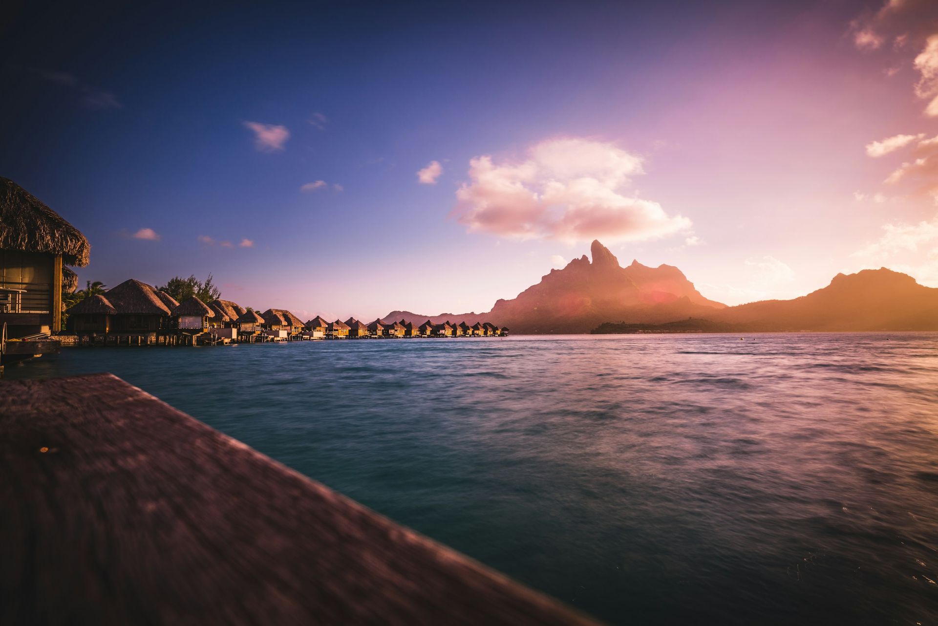 Overwater bungalows in Bora Bora with turquoise lagoon and Mount Otemanu