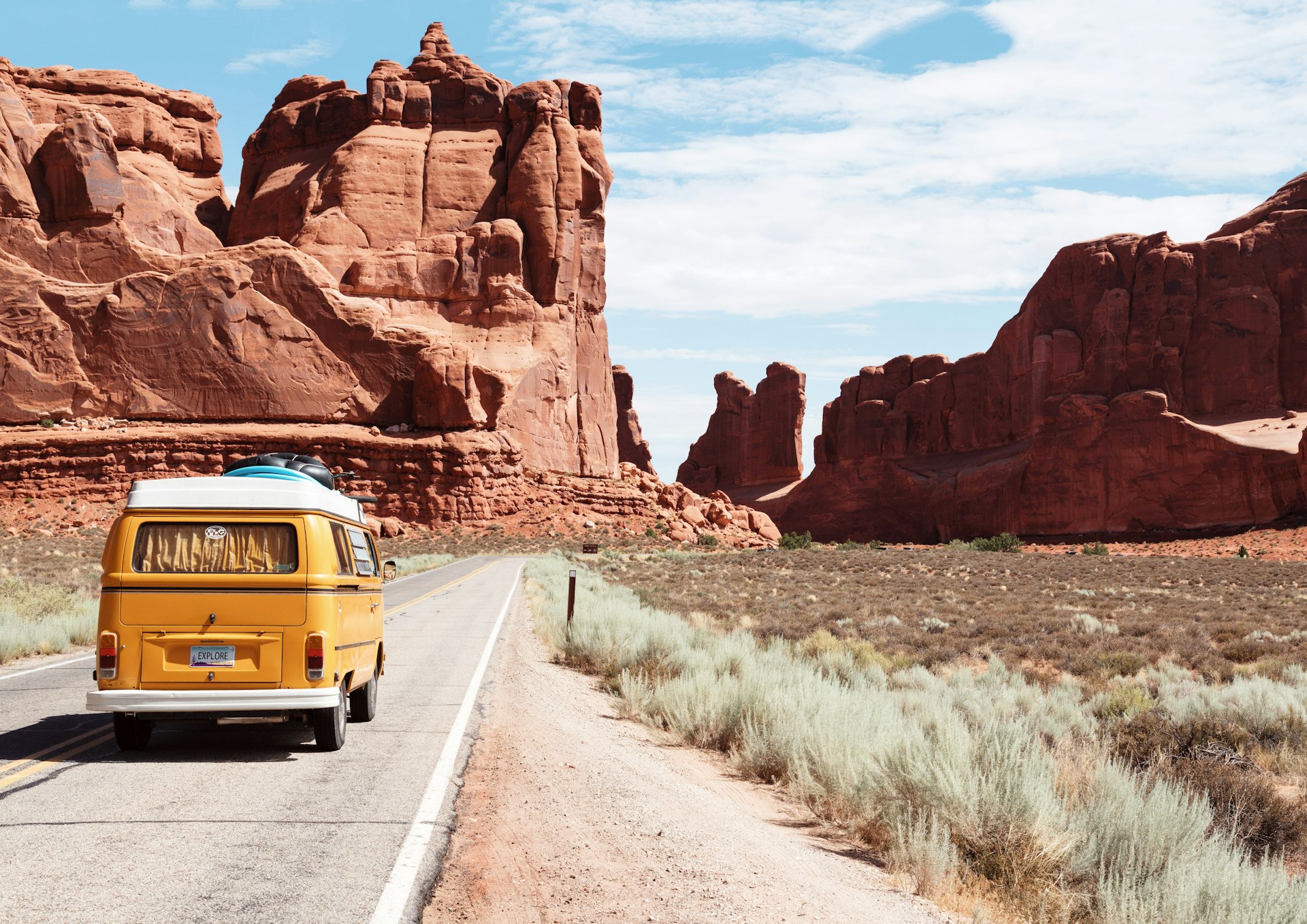 Open road winding through a scenic landscape at golden hour