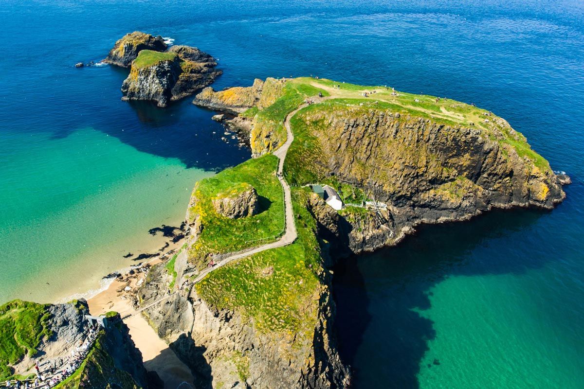 Rolling green Irish countryside with a historic castle in the distance