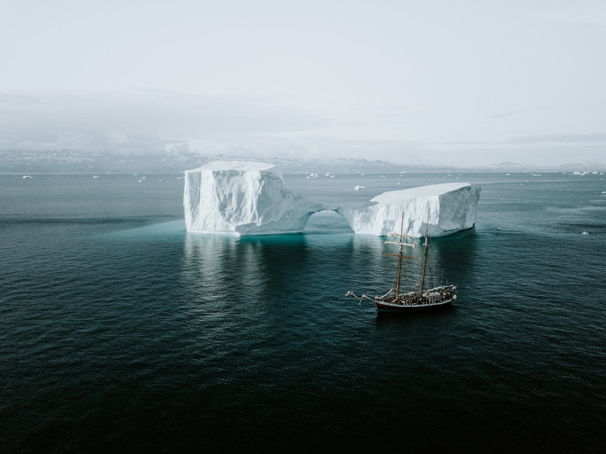 Expedition Zodiac near glacier with passengers photographing wildlife