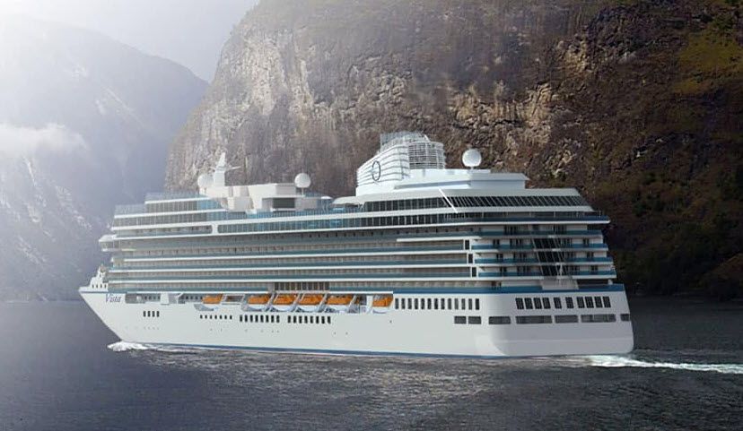 Oceania cruise ship anchored near a scenic Mediterranean coastline