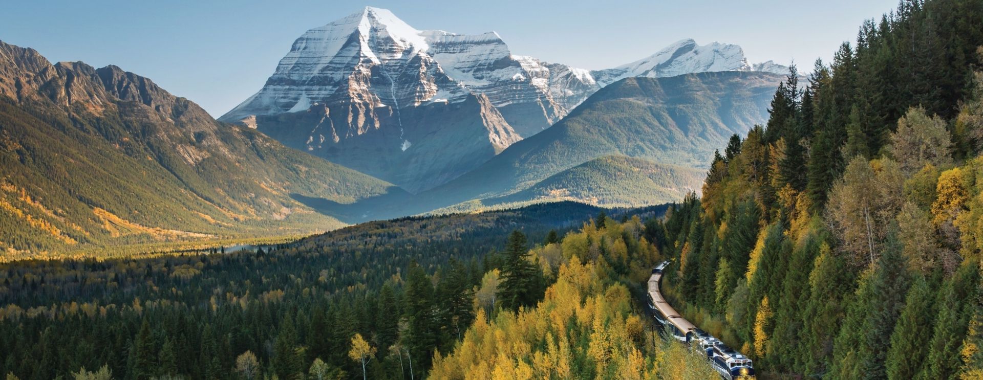Rocky Mountaineer train winding through dramatic mountain scenery