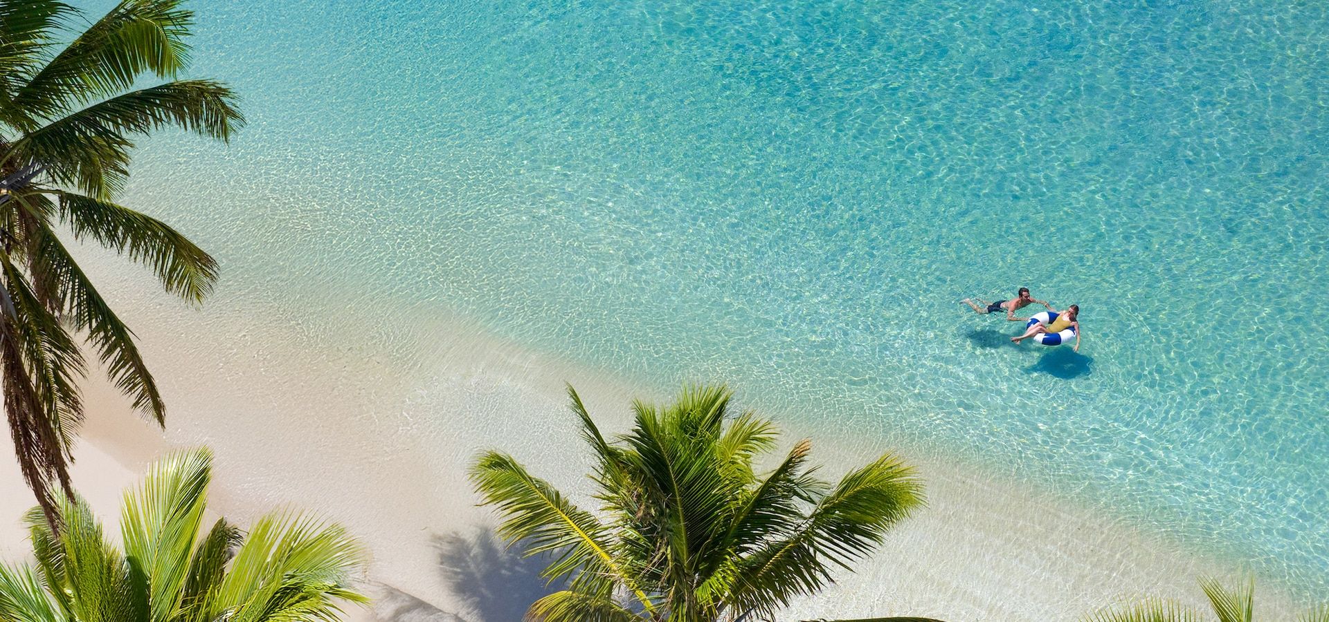 Overwater bungalow suite at a Caribbean Sandals resort with turquoise water